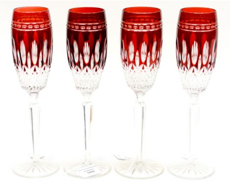 A set of four Waterford Clarendon ruby flutes, faceted stems and star cut bases, plus boxes (4) 