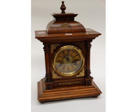 A bracket clock/table clock, fillials, and key within, brass dial, late 19th, early 20th century 