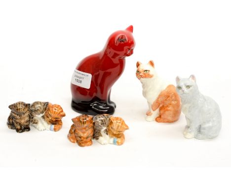 A Royal Doulton Flambe seated cat with four Royal Worcester cats and kittens, including purple backstamp 3141, etc (5) 