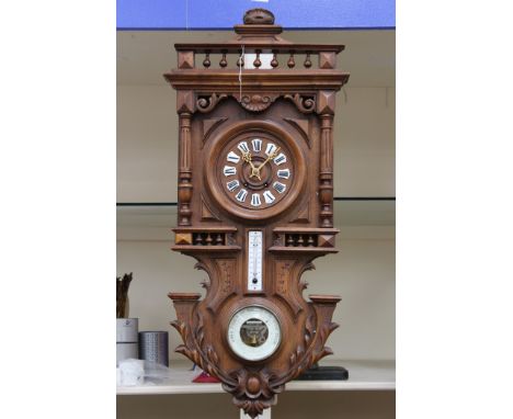 A French wall clock 19th century with Android barometer and thermometer, in centigrade, carved wood detail, enamel dial numer