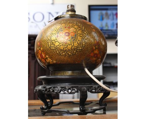  A Kashmir papier - mache table lamp, of globular form, richly decorated in coloured enamels and gilding with roundel's, on a