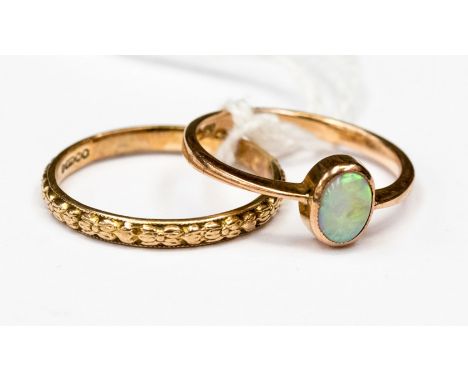 An opal 9ct rose gold ring, the bezel set opal measuring approx 6 by 4.5 mm, ring size M½; together with a 9ct rose gold fanc