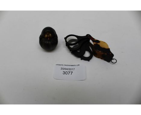 A tortoiseshell, four section eye glass, and a Japanese novelty netsuke 
