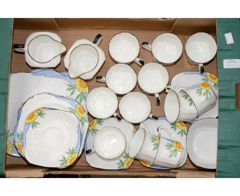 A fine china 1930s tea service comprising of twelve cups - saucers and tea plates, two milk jugs, one sugar and two sandwich 