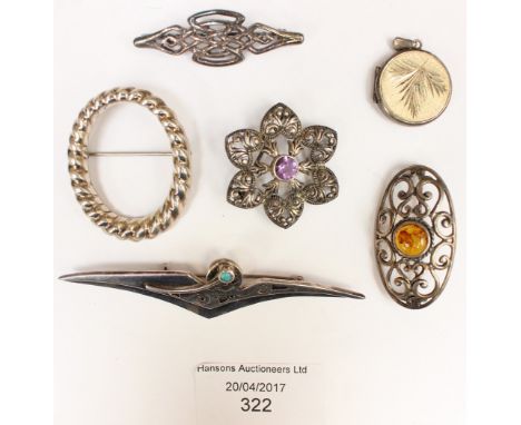 A silver locket, an amber and silver brooch, a Celtic style design sterling silver brooch and another silver brooch; a silver