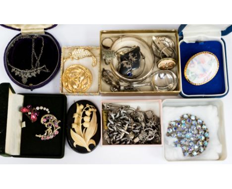 A silver caddy spoon with two silver bracelets weighing approx 1.39 ozt, a white metal charm bracelet and charms weighing app