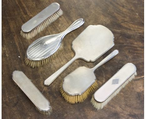 A George V silver dressing table brush set, Walker and Hall, Sheffield 1931, comprising hair brush, clothes brush and mirror,