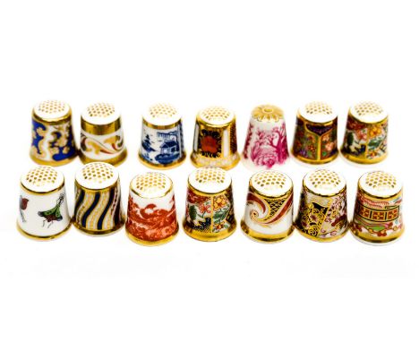 A Royal Crown Derby collection of thimbles, mostly Imari, comprising 13 in total and a Spode thimble (14) 