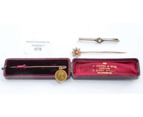 A 1874 one dollar gold coin on rose metal shepherds hook stick pin, a coral and seed pearl flowerhead 9ct. yellow and rose go