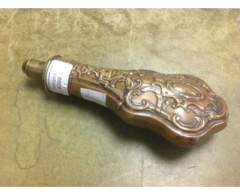 A shotgun powder flask, raised into woven scroll design on copper with brass measure cap 