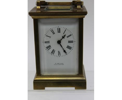 A late Victorian brass carriage clock, made by Finnigan, Manchester, bevelled edge glass, winder to back 