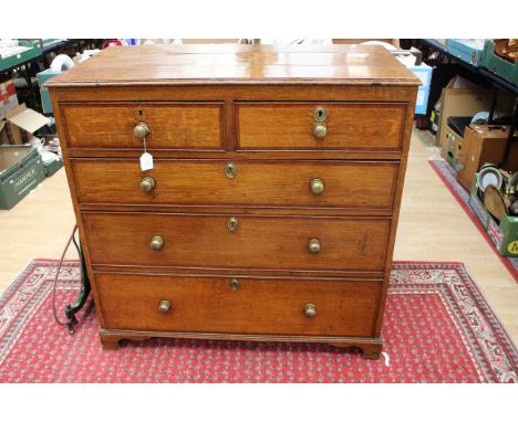 A George III oak and mahogany chest of drawers, comprising two short over three long graduated drawers, the drawers with cros