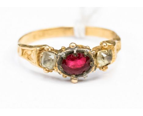 An early 19th century ring, high carat gold, engraving to outer edge of ring, set with possibly garnet and citrines size M 1/