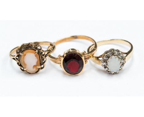 Three 9ct gold dress rings comprising a garnet set, a cameo and an opal and diamond approx 6.3gms 