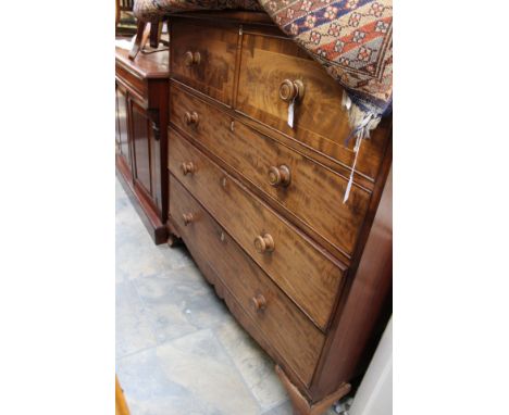 An early Victorian mahogany chest of drawers, the upper section with a hinged top, enclsing single storage compartments below