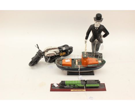 A model train, life boat, motorbike and a Charlie Chaplin figure 