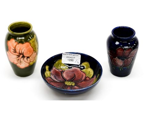 Two Moorcroft vases, with a trinket dish, two anemone pattern on cobalt and one anemone on green ground (3) 
