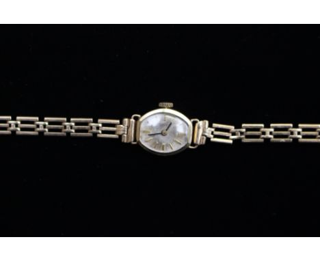A ladies vintage 14ct gold watch on a 9ct gold bracelet 