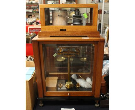 A barrow graph in case, along with cased scales 