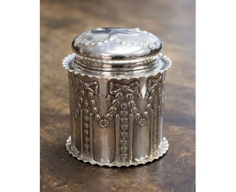 A silver trinket/powder pot and cover with down powder puff, the pot and cover being embossed with foliate and floral swags, 