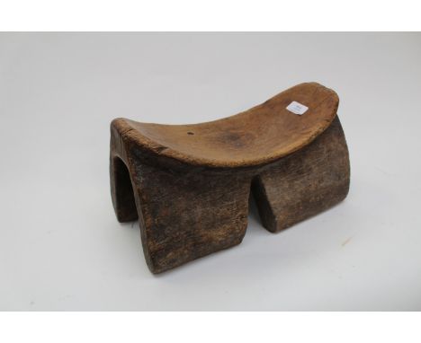 Tribal art, a 19th Century African tribal wooden head rest, of dished from on four bracket feet, width 36cmCondition Report: 