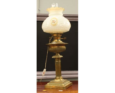 A brass oil lamp, column form with glass shade and funnel 