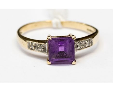 A 9ct gold amethyst and diamond chip ladies dress ring, the single bevelled cut amethyst flanked by diamond chip shoulders, r