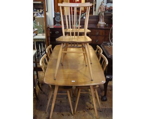 Ercol elm and beech refectory dining table and six chairs.