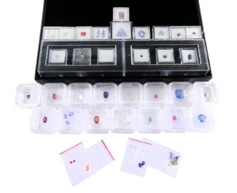 Collection of loose gemstones including tanzanite, fluorite, rubellite, opal, tourmaline, rhodolite garnet, emerald, ruby and