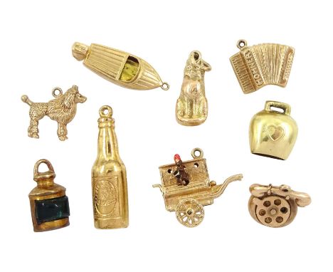 Eight 9ct gold pendant / charms including Guinness bottle, monkey organ grinder, boat, cat, poodle dog, telephone and lantern
