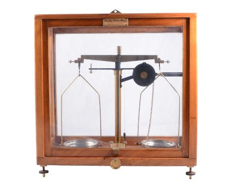 Set of pharmaceutical beam balance scales, Griffin &amp; Tatlock Limited, in a glazed case, with weights, height 43cm.