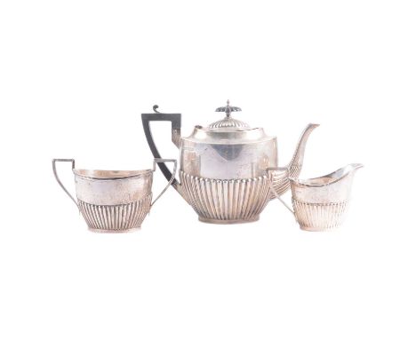 Silver three-piece tea set, Walker &amp; Hall, Sheffield 1929 (teapot) &amp; 1932 (milk and sugar), semi fluted bodies, ebony