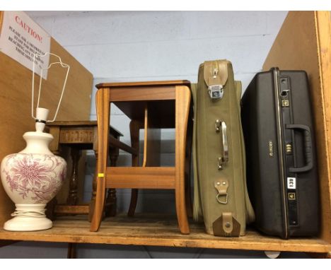 A lamp, an occasional table, suitcases and a magazine rack 