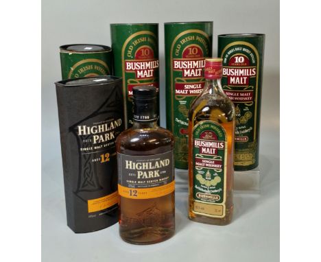 Three bottles of Bushmills Single Malt Whiskey, ten years old in tubular boxes, 1 litre, together with another Bushmills bott