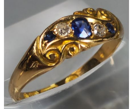 Edwardian 18ct gold diamond and sapphire five stone ring of scroll form. Birmingham hallmarks. 2.6g approx. size K. (B.P. 21%