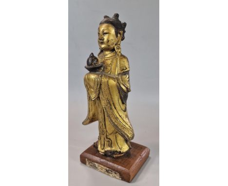 Chinese Ming standing gilt bronze figure of Longnu, holding a sacrificial bowl containing a flaming pearl on associate wooden