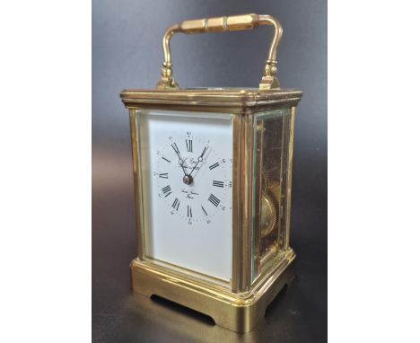 French brass carriage clock with full depth Roman white face, marked 'Lamb, Lucerne, France'.  Complete with key.  14cm high 