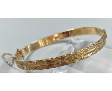 9ct gold engraved christening bangle. 6cm diameter approx. 11.5g approx. (B.P. 21% + VAT)