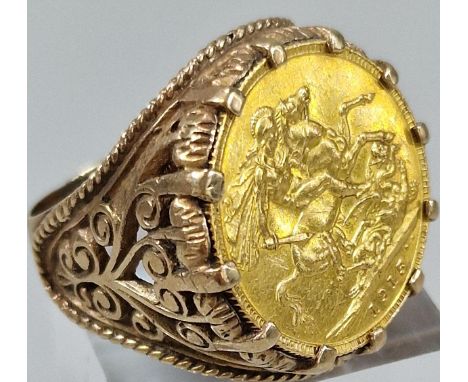 George V gold full Sovereign dated 1915 set in a 9ct gold pierced foliate ring mount. Total weight 18.4g approx. (B.P. 21% + 