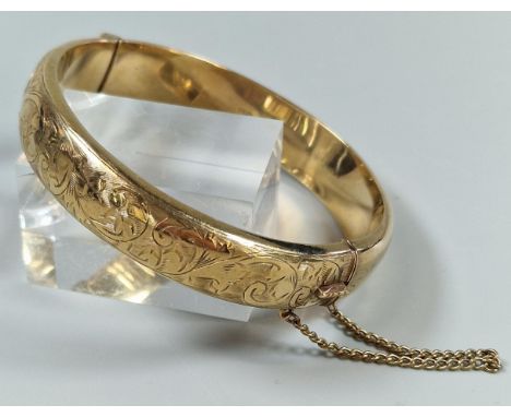 9ct gold engraved bangle. 6.5cm diameter approx. 18g approx.   (B.P. 21% + VAT) 