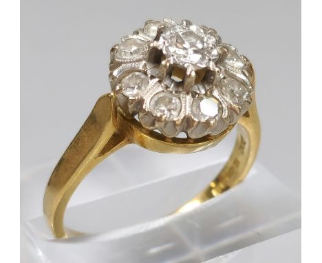 18ct gold diamond flowerhead cluster ring inset with nine diamonds. 6.5g approx. (B.P. 21% + VAT)