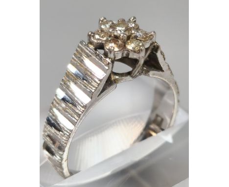 18ct white gold and diamond seven stone flowerhead ring. 5.5g approx. Size M. (B.P. 21% + VAT) 