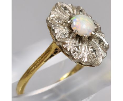 18ct gold ring inset with eight diamonds and central cabochon opal stone. 4.2g approx. Size M. (B.P. 21% + VAT) 