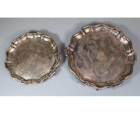 Two George V silver piecrust salvers, both standing on three hoof feet, by Mappin &amp; Webb Ltd, Sheffield 1930.  25cm and 1