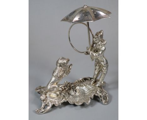 Unusual white metal, probably continental circus figure group of a harlequin with umbrella and ring with seated lion on rococ