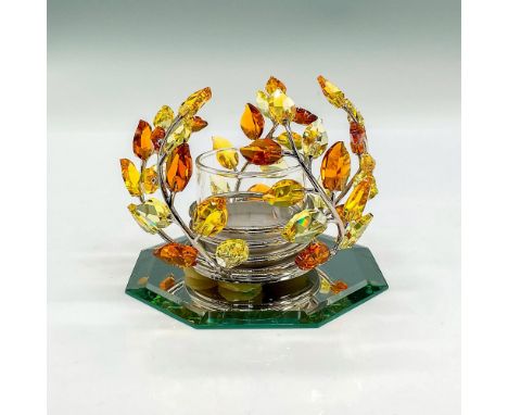 Orange and yellow crystal leaves on a rhodium frame that surrounds a glass tea light holder; 4"L x 4"W x 3"H. This is attache
