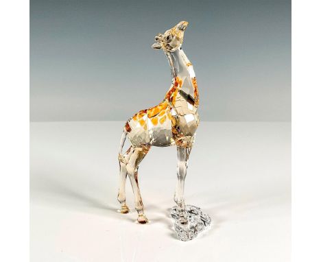Multifaceted crystal clear to light brown, with brown eyes and back spots. Swarovski etched backstamp. This item has its orig