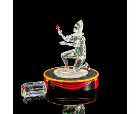 Stunning clear crystal Harlequin kneeling, presenting a red crystal rose with rhodium stem. Satin base and face. Swarovski Cr