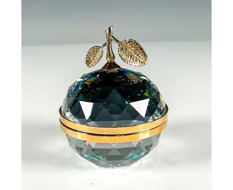 This hinged, faceted paperweight is designed as an apple and is banded with gold toned rhodium as well as the stem and leaf. 