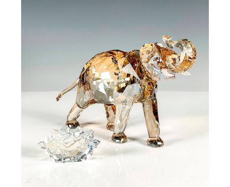 Swarovski Crystal Figurine featuring Cinta Elephant and Plaque. This clear, amber-colored crystal elephant, adorned with fros